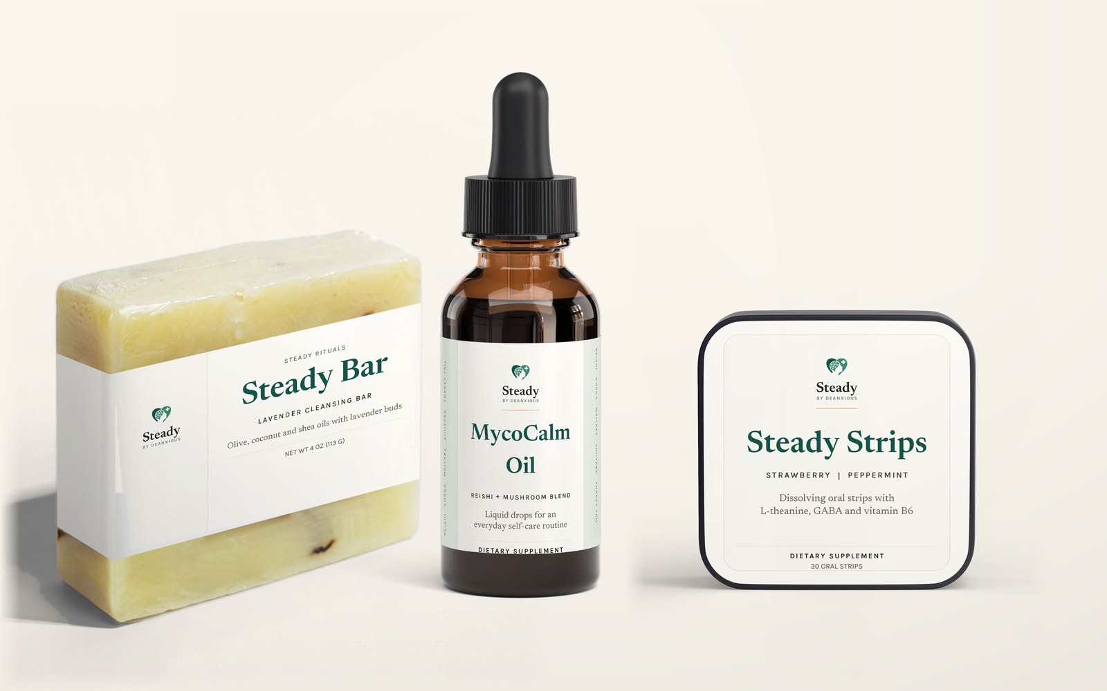 The Steady Rituals Collection: the MycoCalm Oil dropper bottle, the Steady Strips tin and the lavender Steady Bar arranged together on a warm cream ground.